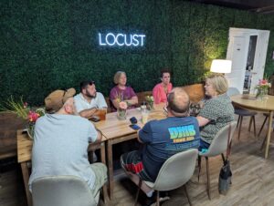 People gathered talking to each other at a Biz Exchange After Hours event