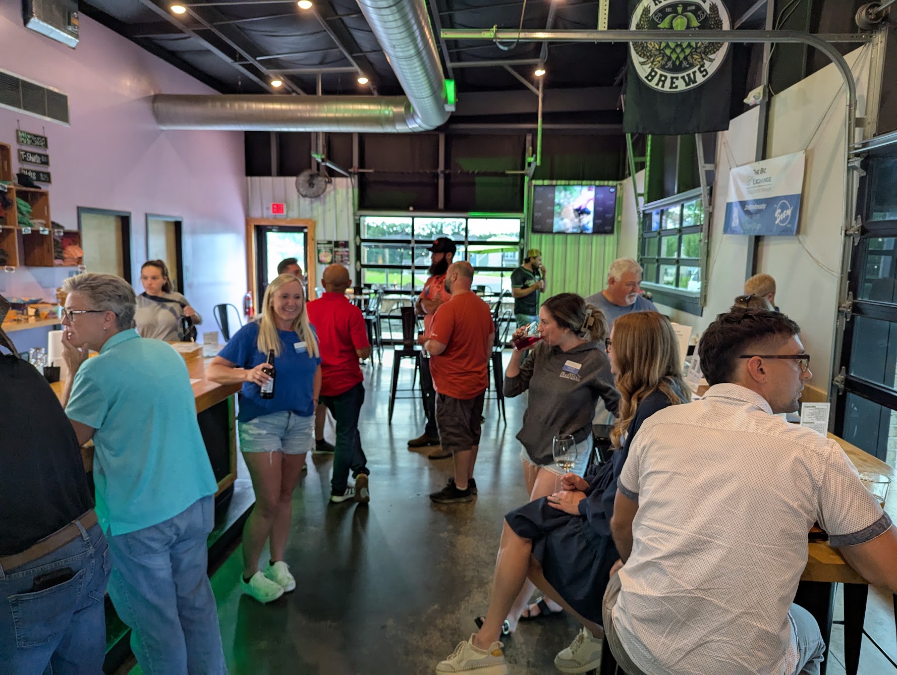 People gathered talking to each other at a Biz Exchange After Hours event